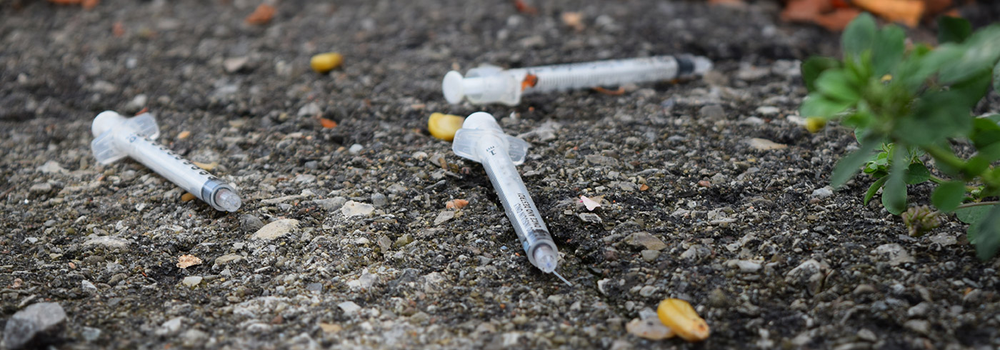 Discarded needles on the ground.