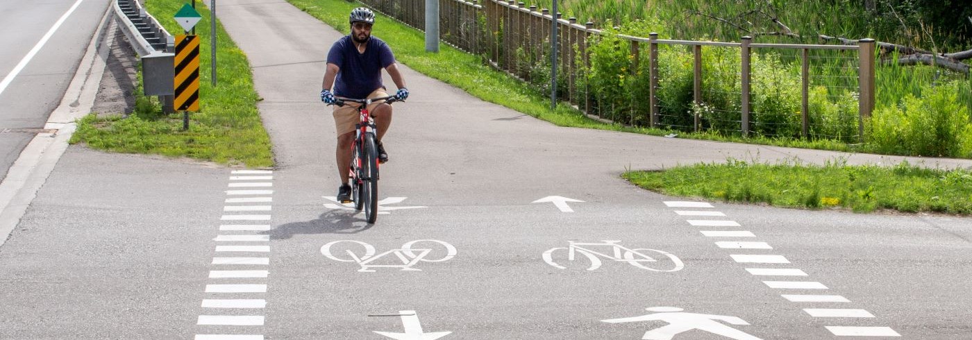 Man cycling across a mixed crossride at an unsignalized crossing