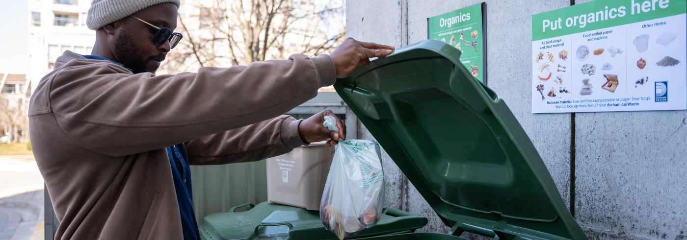 Green Bins outside apartment building