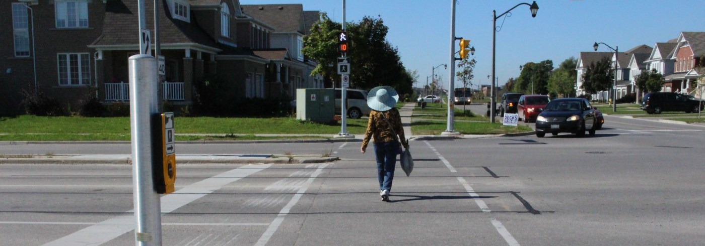 Woman crossing the road at a pedestrian crossing