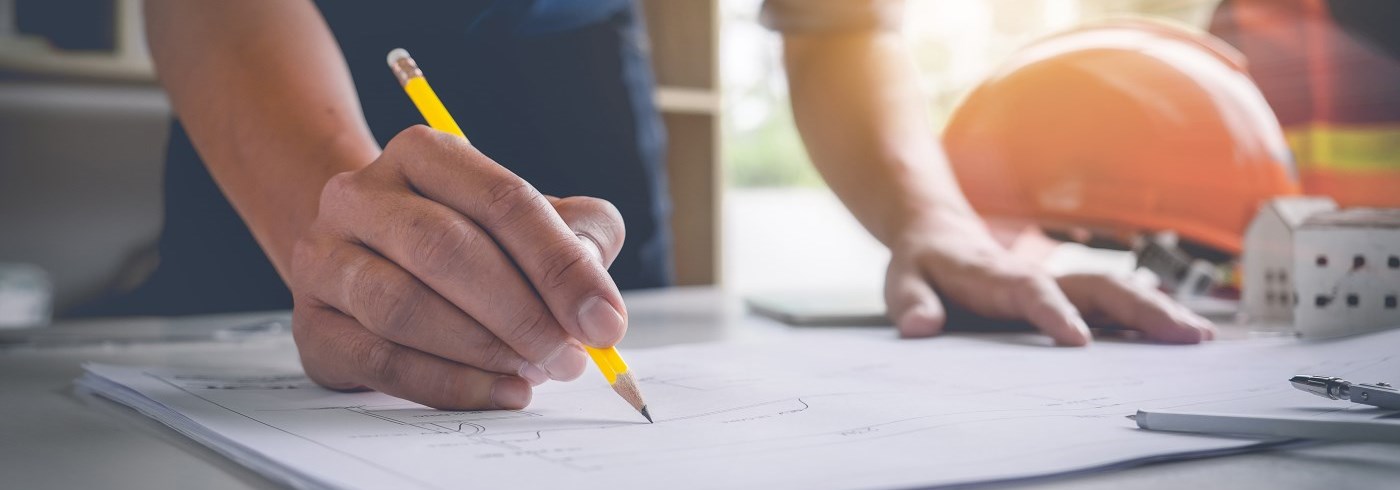 Architect drawing plans on table