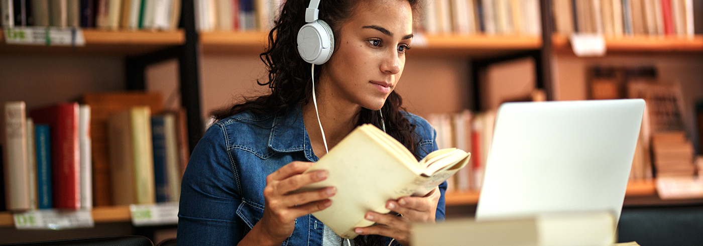 Female studying with book and laptop