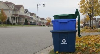 Blue Boxes and Green Bin stacked at the curb