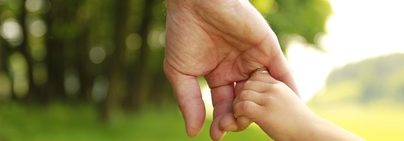 Adult and child holding hands