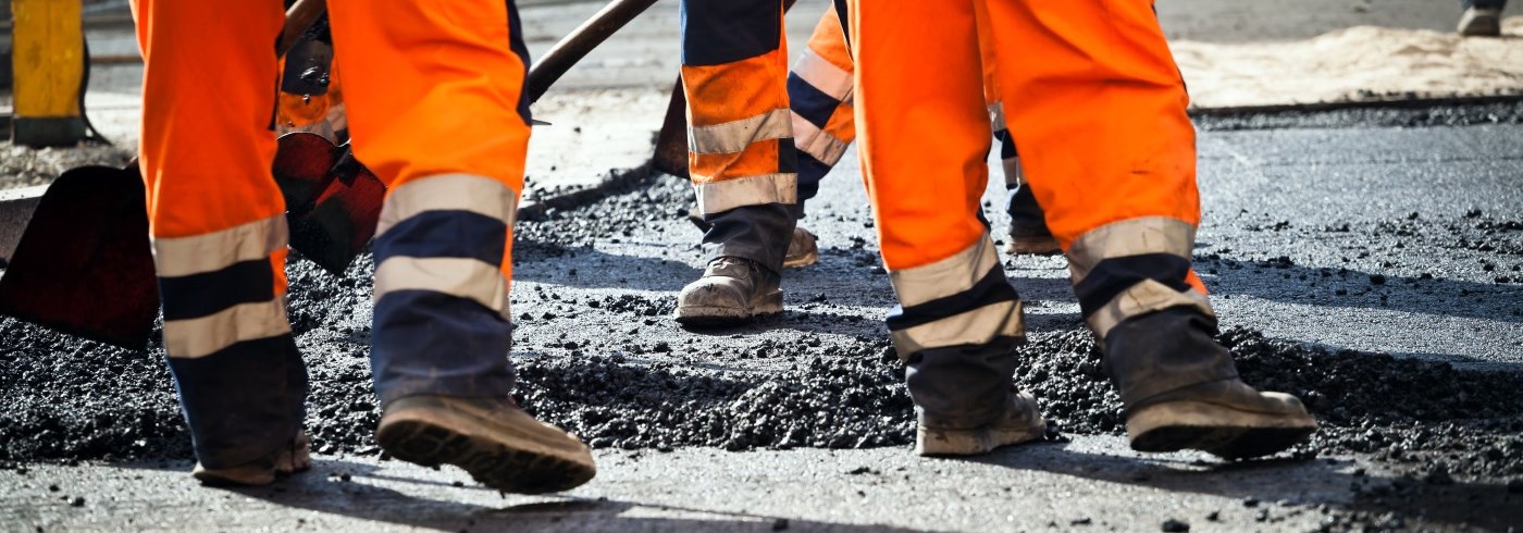 Crew working to fill pothole on road