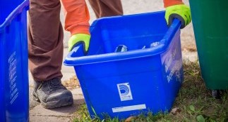 Man picking up a blue box