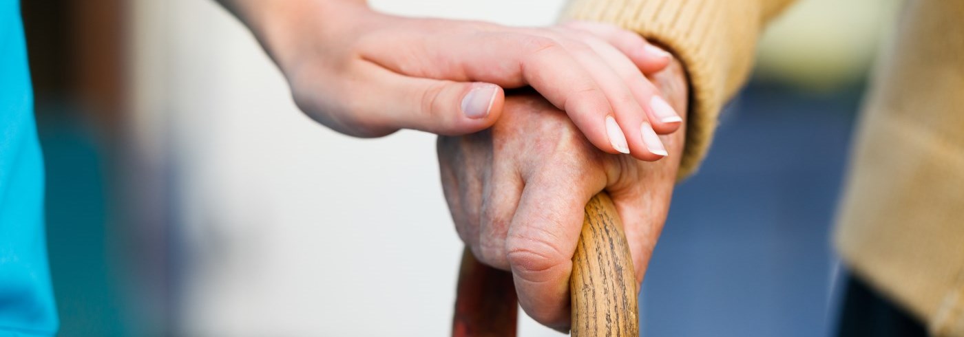 Hands holding a cane