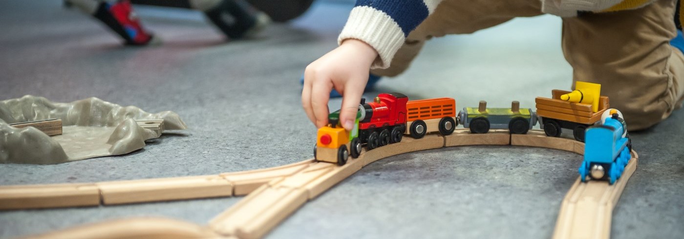 Child playing with toy train