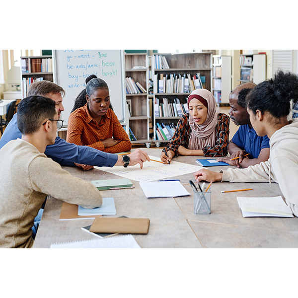 Group of people looking at papers on a table