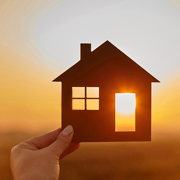 image of a person holding a model of a house