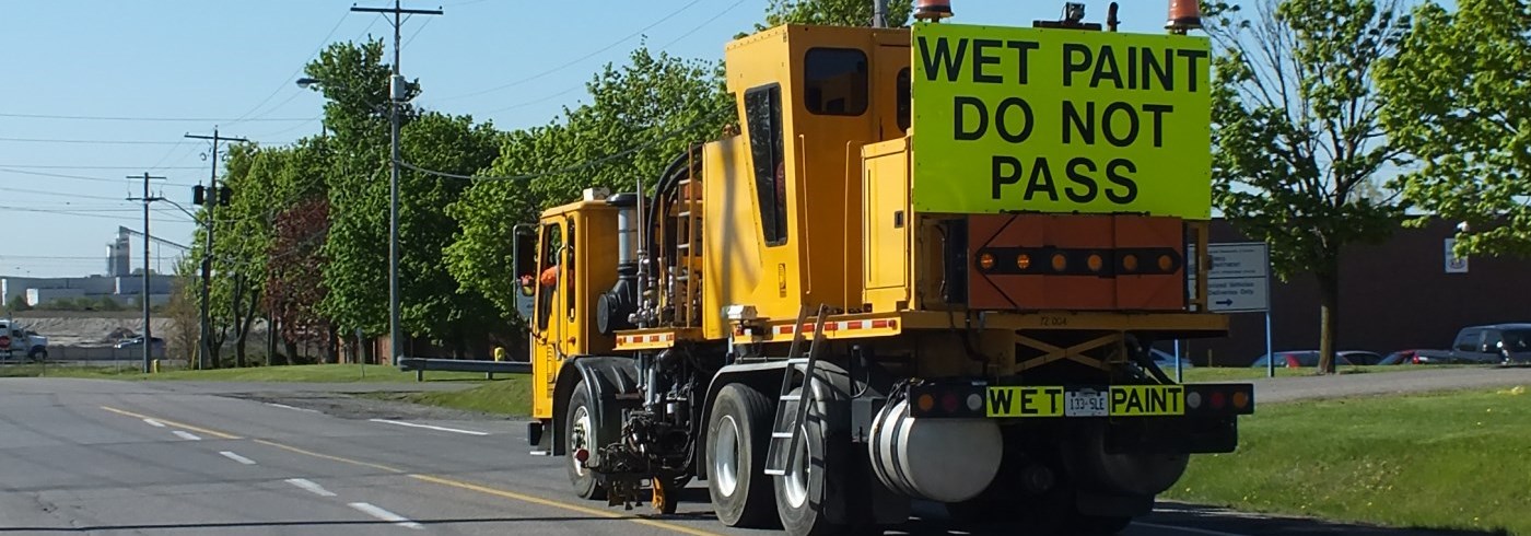 Truck painting line markings on road