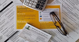 Tax forms, glasses and a calculator