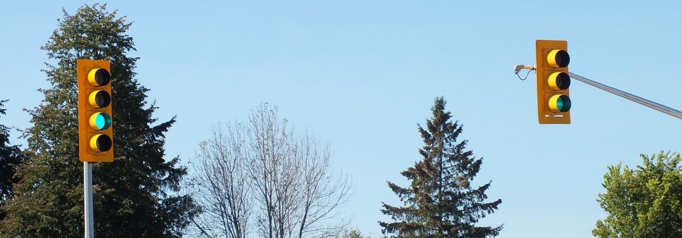 Two traffic signals with green lights