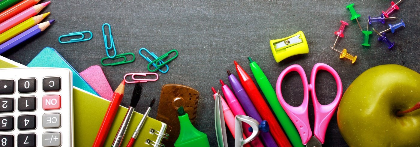 Pencils, calculator, apple on desk