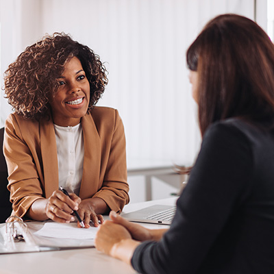 Two individuals meeting in an office