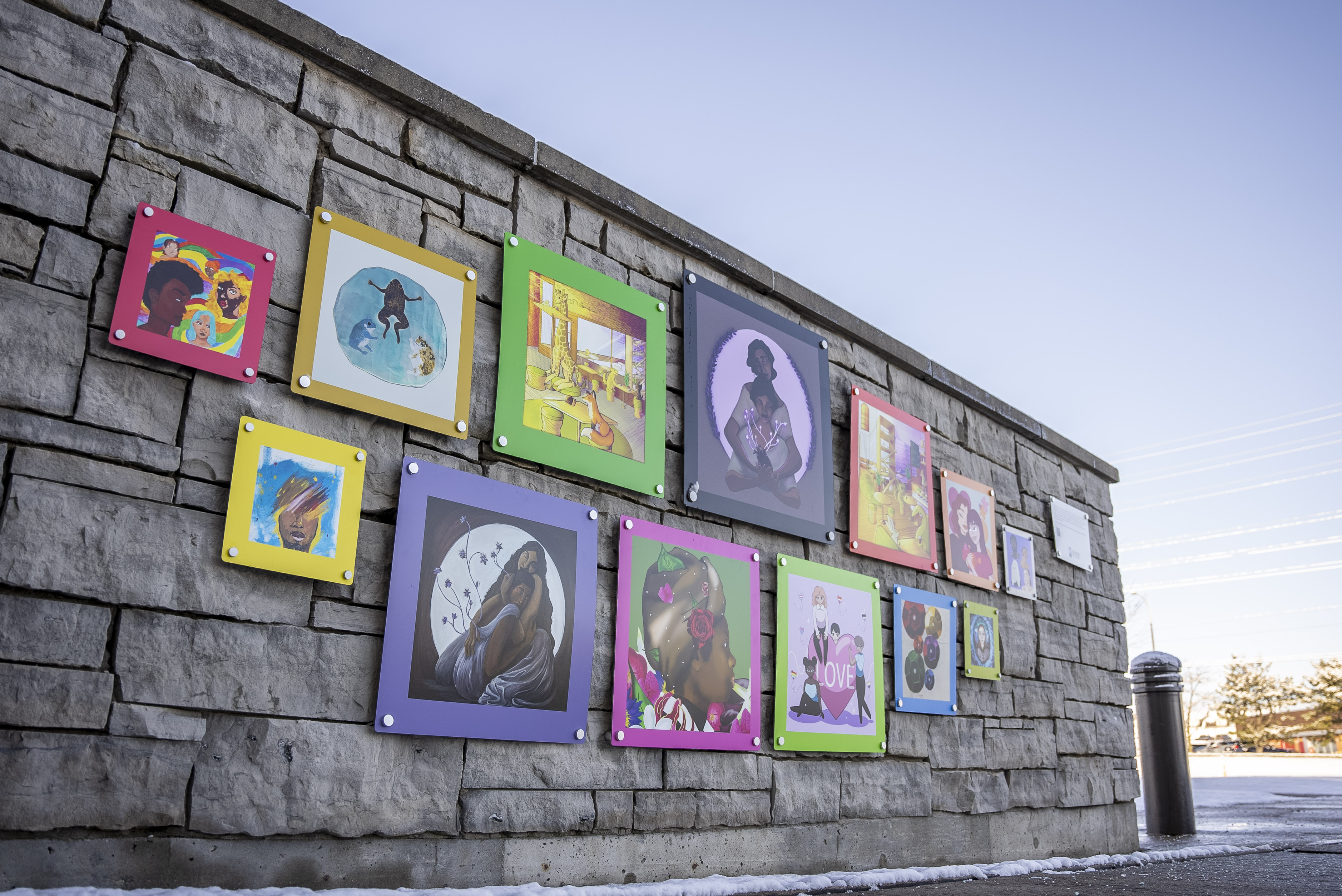Colourful artworks line a stone wall at Durham Regional Headquarters.