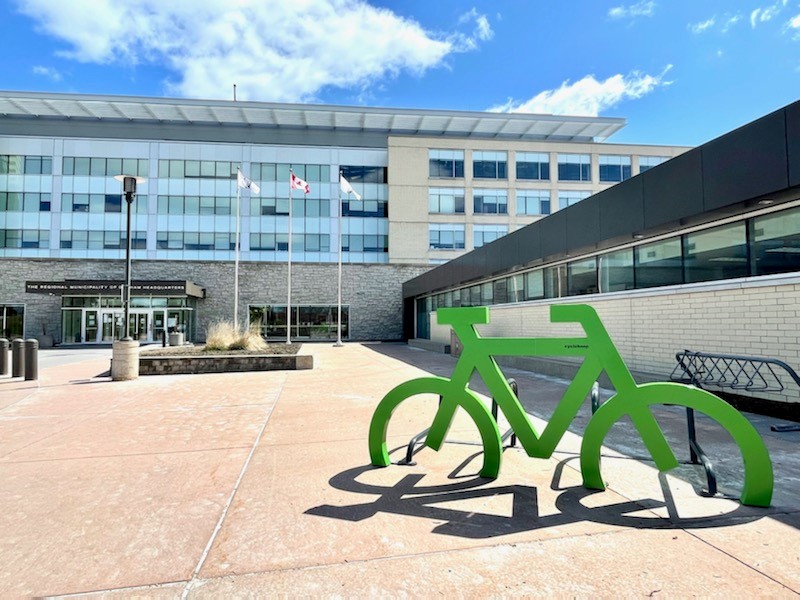 Green bike rack in front of Regional headquarters.