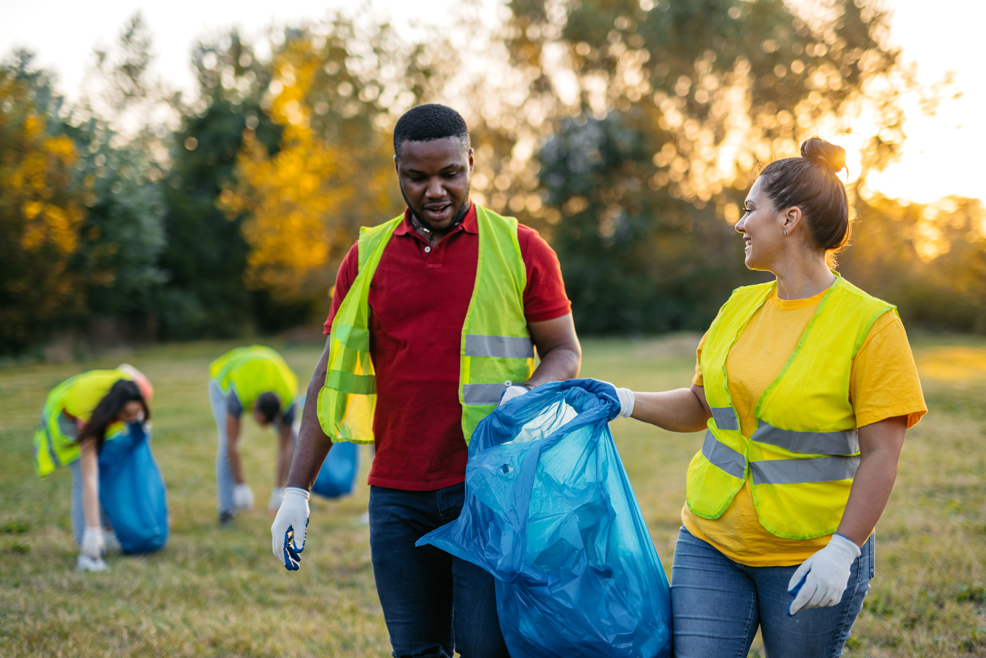 Man and woman picking up garbage