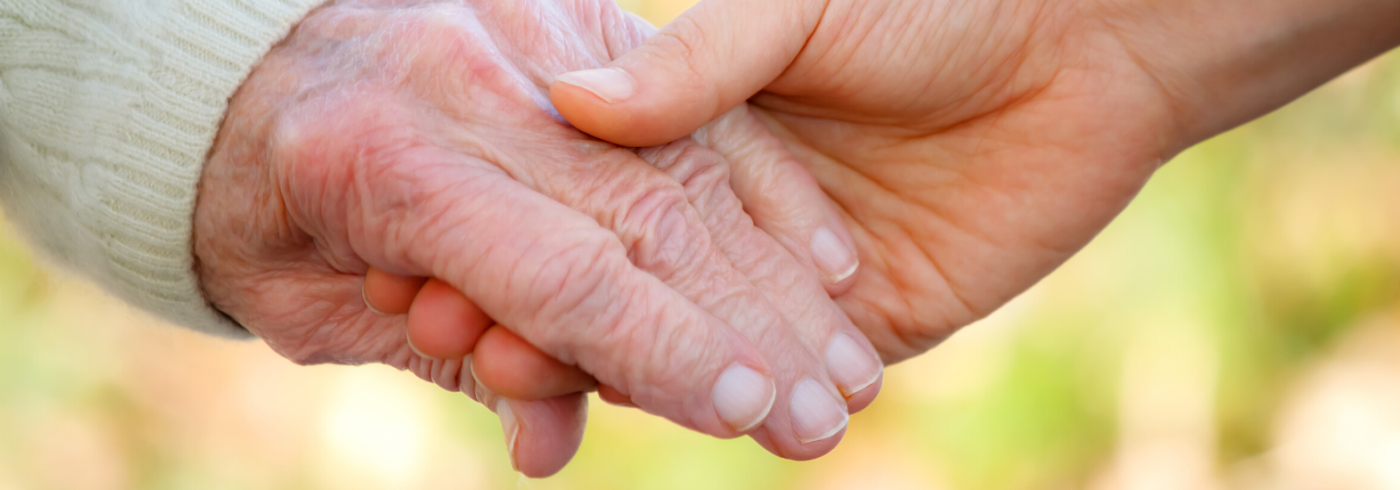 elderly person hand holding another hand