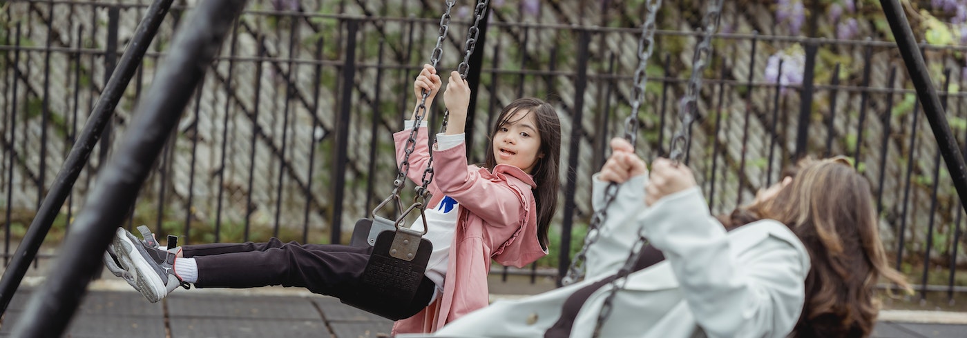Persons in the park on swings