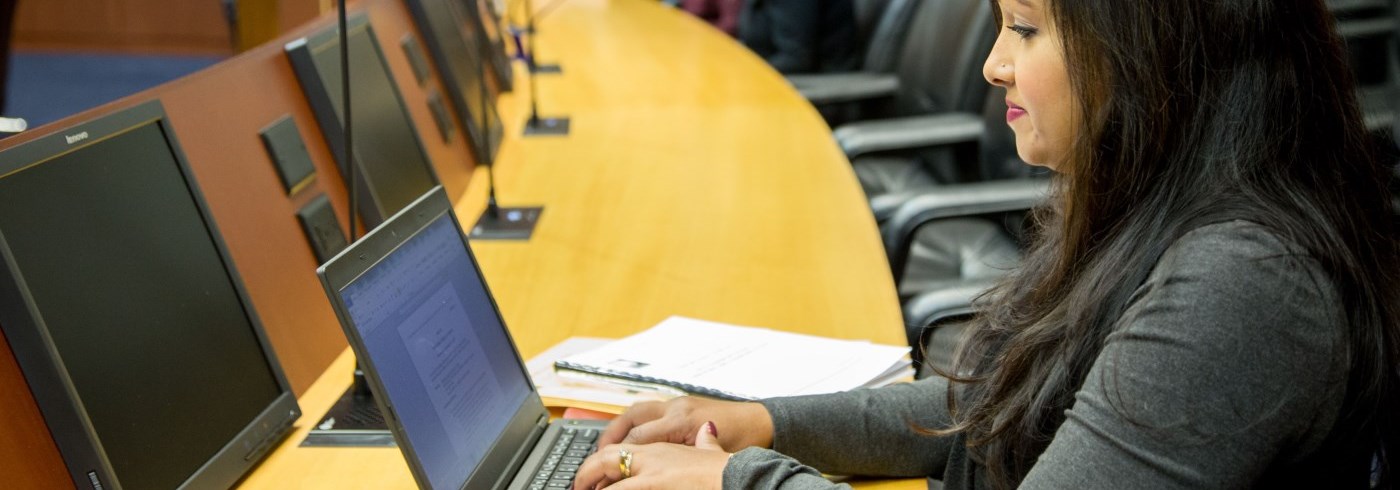 Woman taking minutes on a laptop