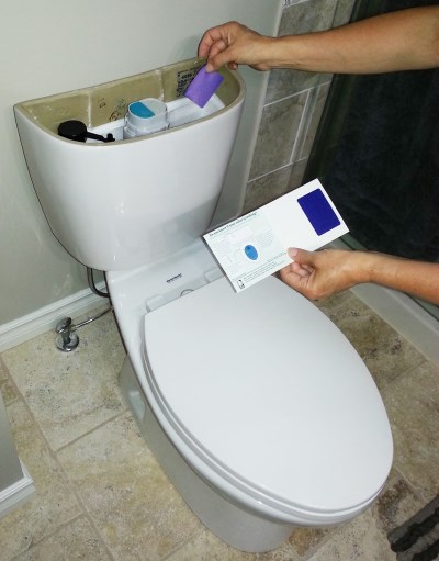 Toilet dye test strip being used