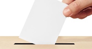 hand putting ballot into box