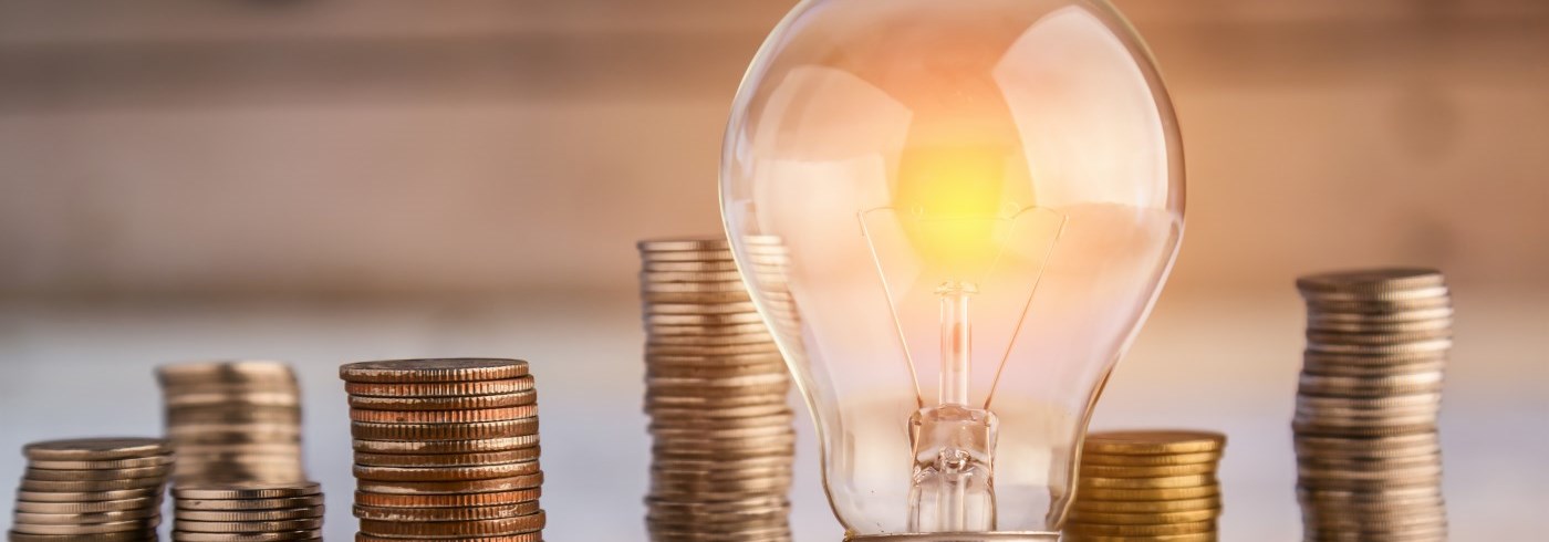 Stacked coins and light bulb