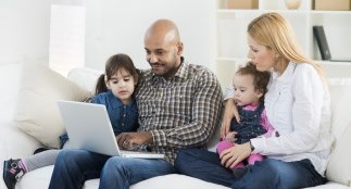 Parents with two children looking at laptop