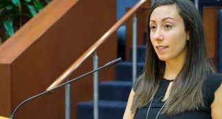 Woman at podium speaking to Regional Council