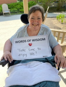Picture of Wendy holding a "Words of Wisdom" sign