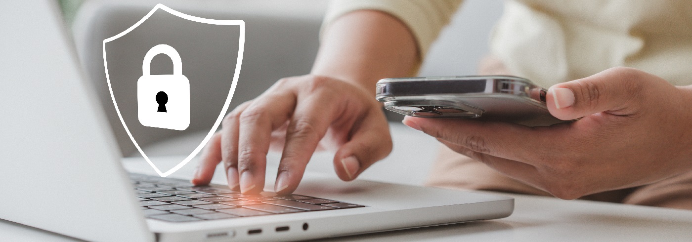 Laptop and phone with symbol floating of a shield with a lock in it