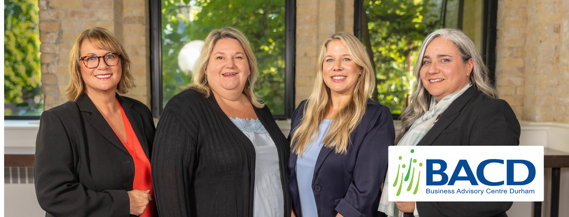 4 members of BACD team standing with BACD logo in bottom right