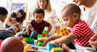 Children and adults playing with building blocks