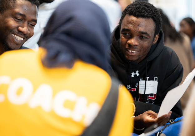 A group of people talking and working together