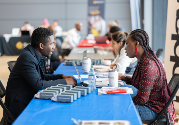 People talking and learning together at a display table