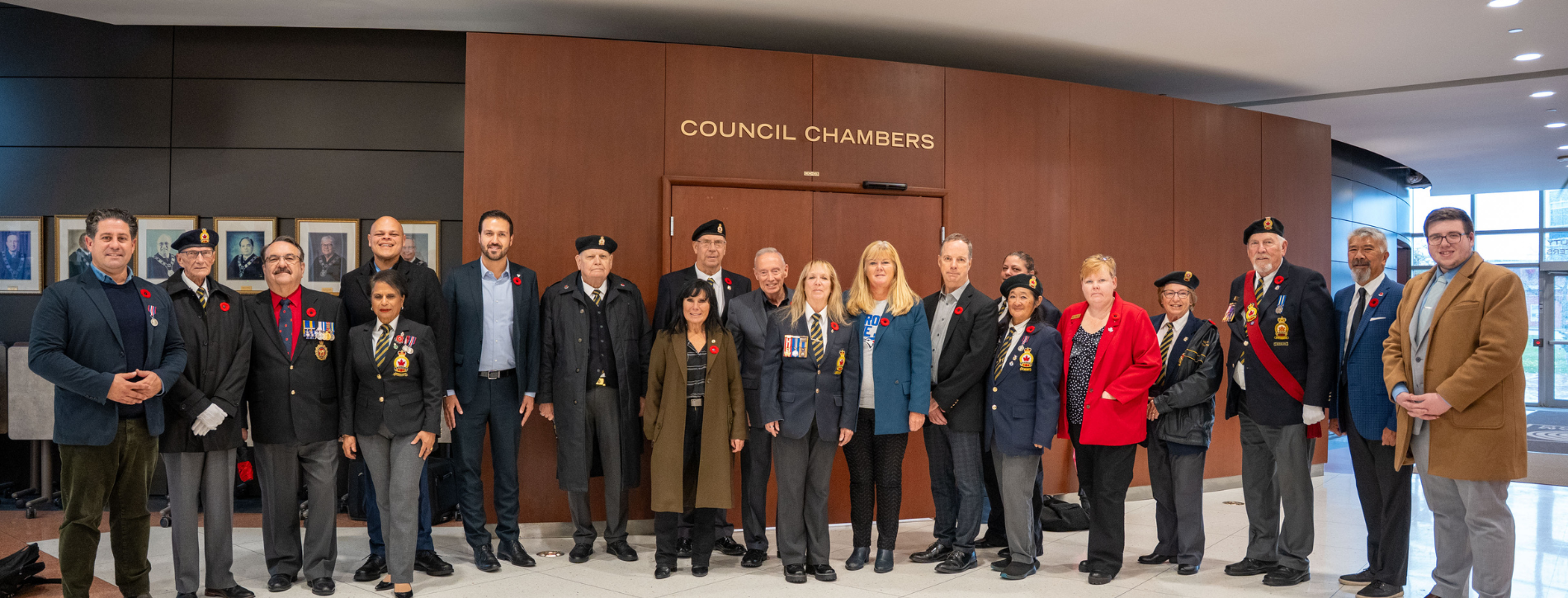 Members of Regional Council and Canadian Armed Forces stand outside Regional Council Chambers.