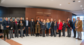 Regional Councillors and members of the Canadian Armed Forces pose for a picture outside Regional Council Chambers.