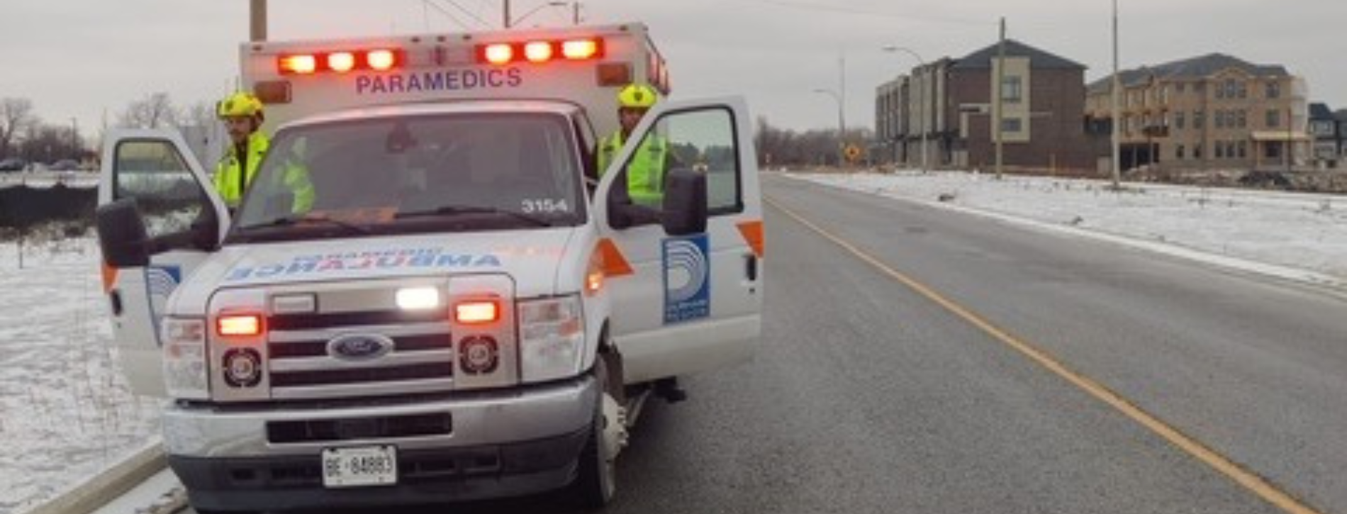 A Durham ambulance pulled over to the shoulder on a busy road.