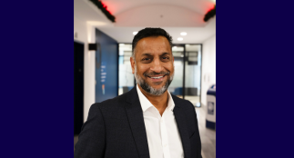 A head shot of Riaz with a blurred background.