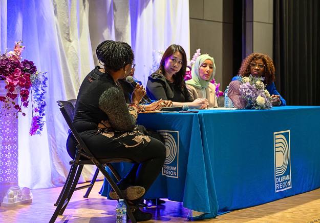 Panelists speaking at the event
