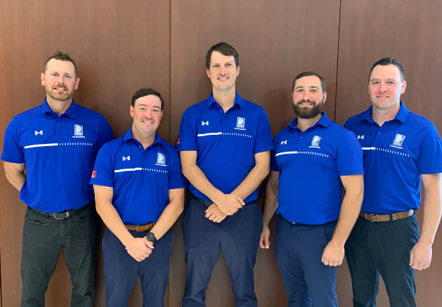 A photo of five Durham Region’s Sludgehammer team members in blue shirts.