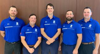 A photo of five Durham Region’s Sludgehammer team members in blue shirts.