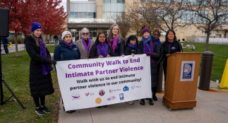 A group of women holding a sign at the IPV walk.