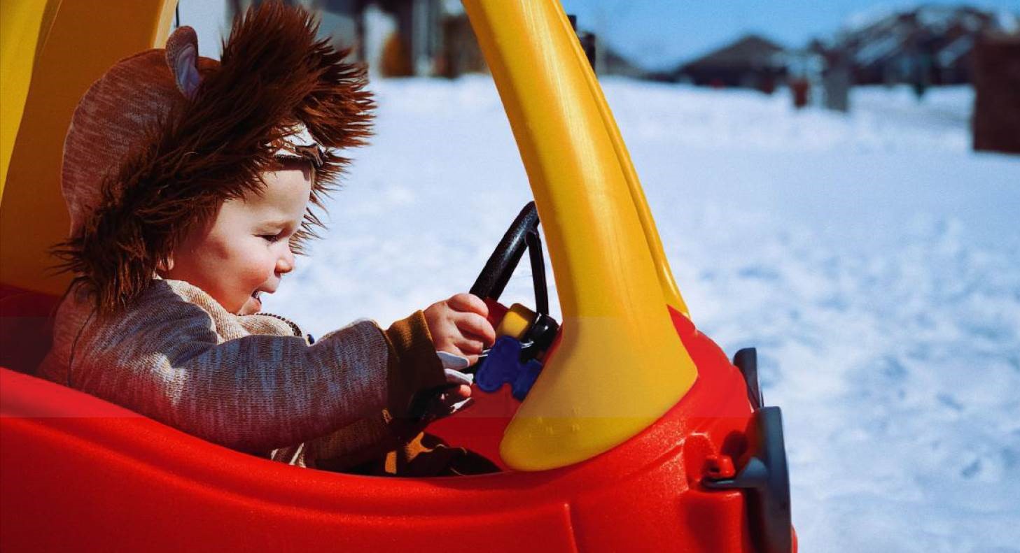 GROW Winter 2023 Picture Child riding in toy car