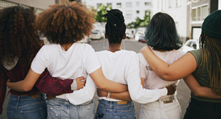 A group of people with the arms linked behind their back.