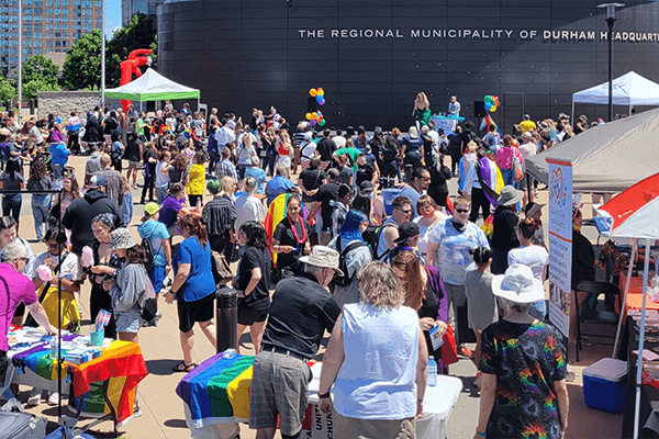 A large crowd at an event in front of Durham Regional Headquarters