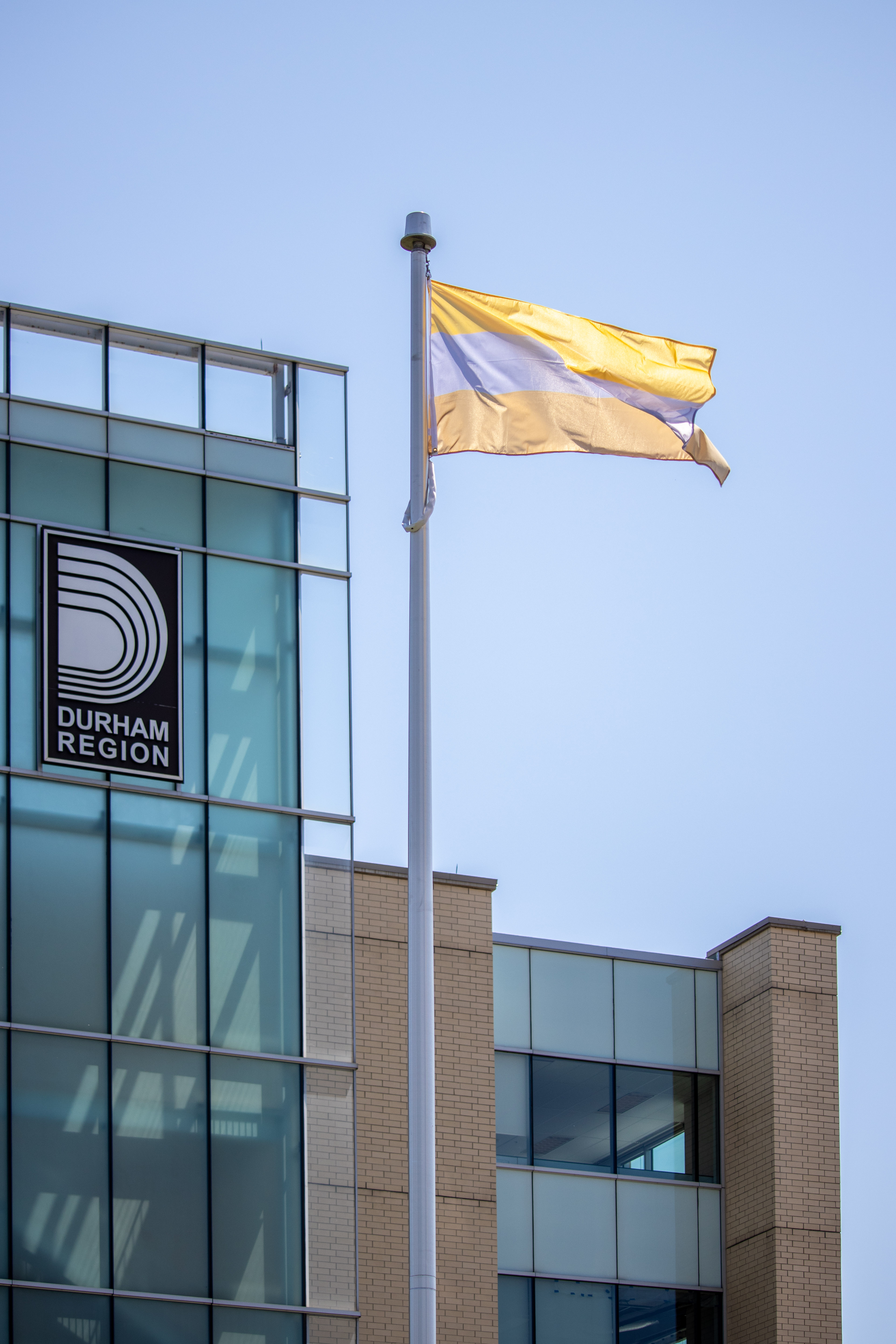 Disability Flag raised in front of Durham Regional Headquarters
