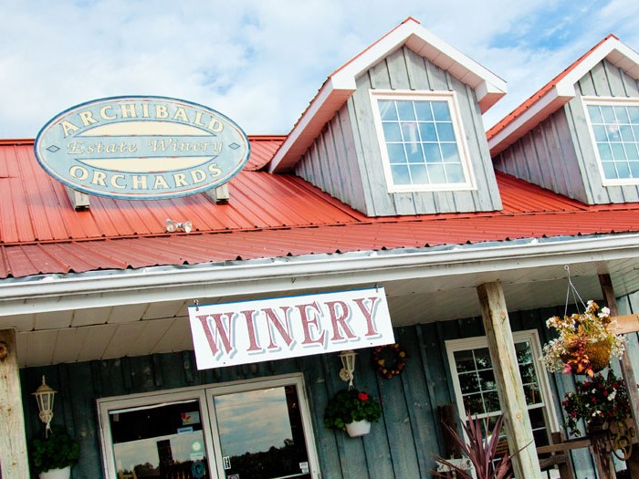 An exterior photo of Archibald's Orchards and Winery on a sunny blue sky day