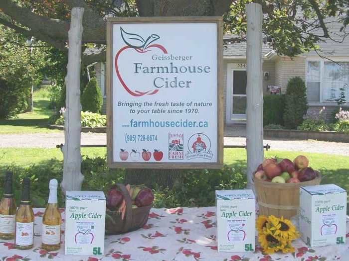 A product display in front of the Geissberger Farmhouse Cider store feature cider and hard cider prodcuts